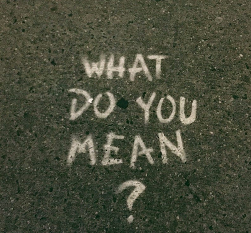 what do you mean? text on gray surface what do you mean? text on gray surface