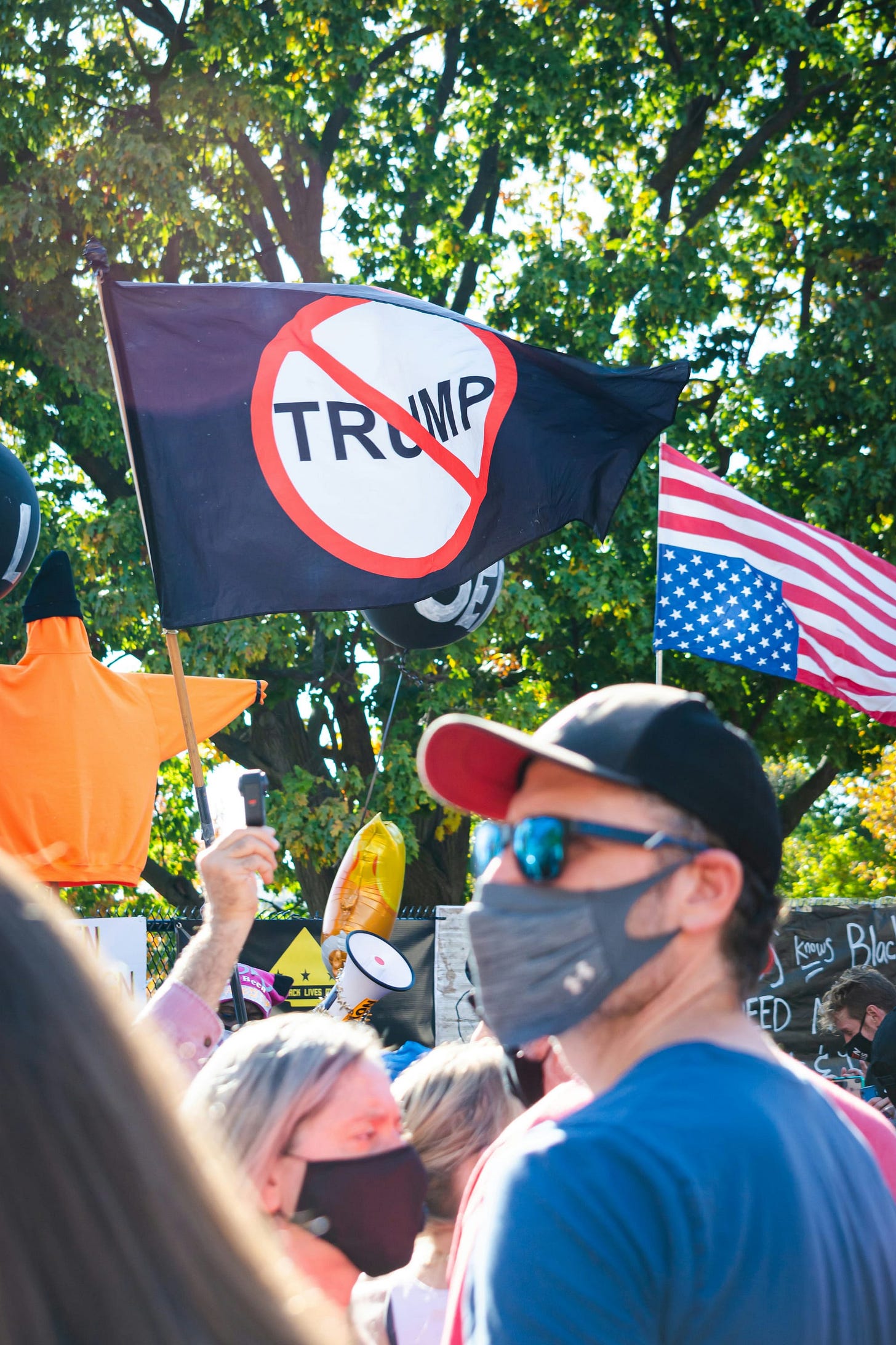 Protestors, featuring an anti-Trump sign and upside-down flag Protestors, featuring an anti-Trump sign and upside-down flag