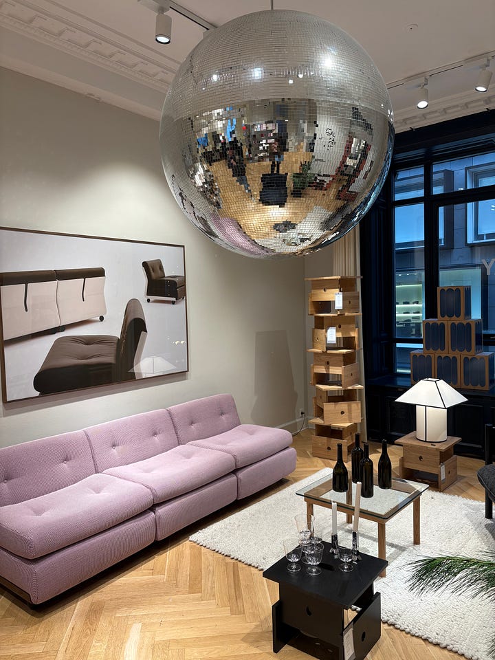 Vinyl records, neon window sign, mirror selfie, a living room with a giant disco ball