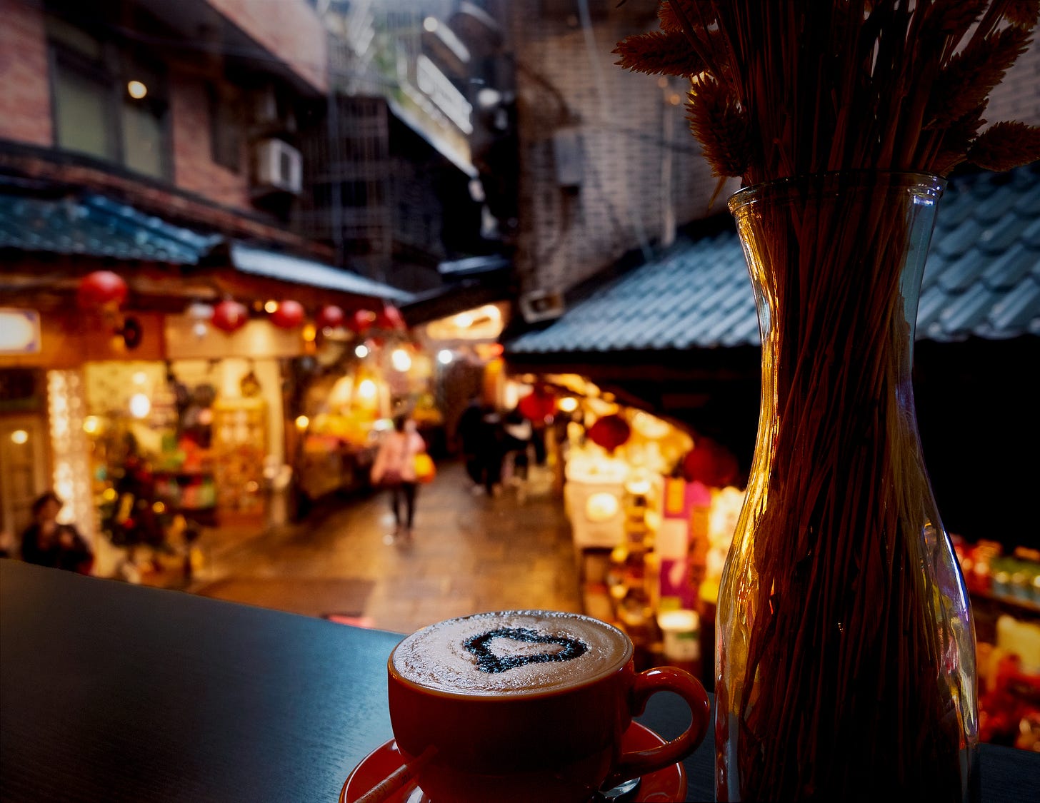 Shops lit up around central intersection of Jiufen Old Street, seen from the window of the cafe in Chiu Chunt Dint Inn Shops lit up around central intersection of Jiufen Old Street, seen from the window of the cafe in Chiu Chunt Dint Inn