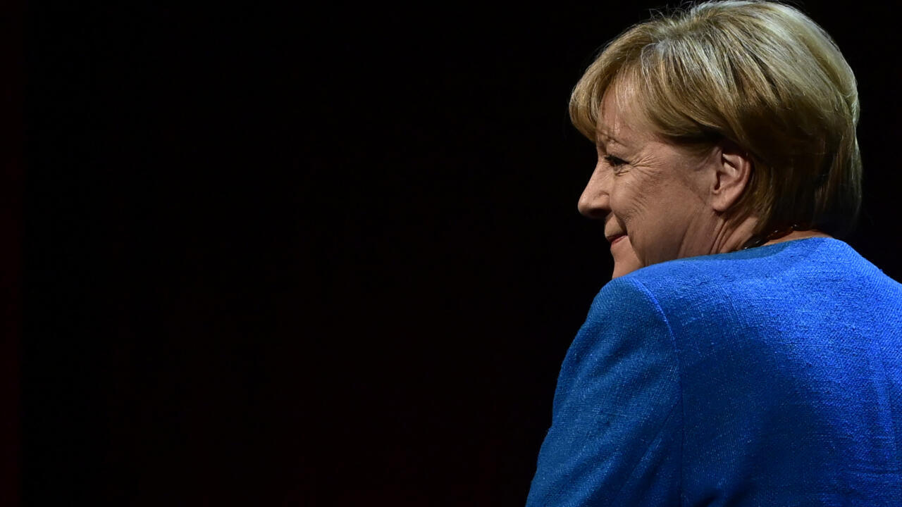 Former German chancellor Angela Merkel arrives on stage for her first public interview since stepping down, on  June 7, 2022.