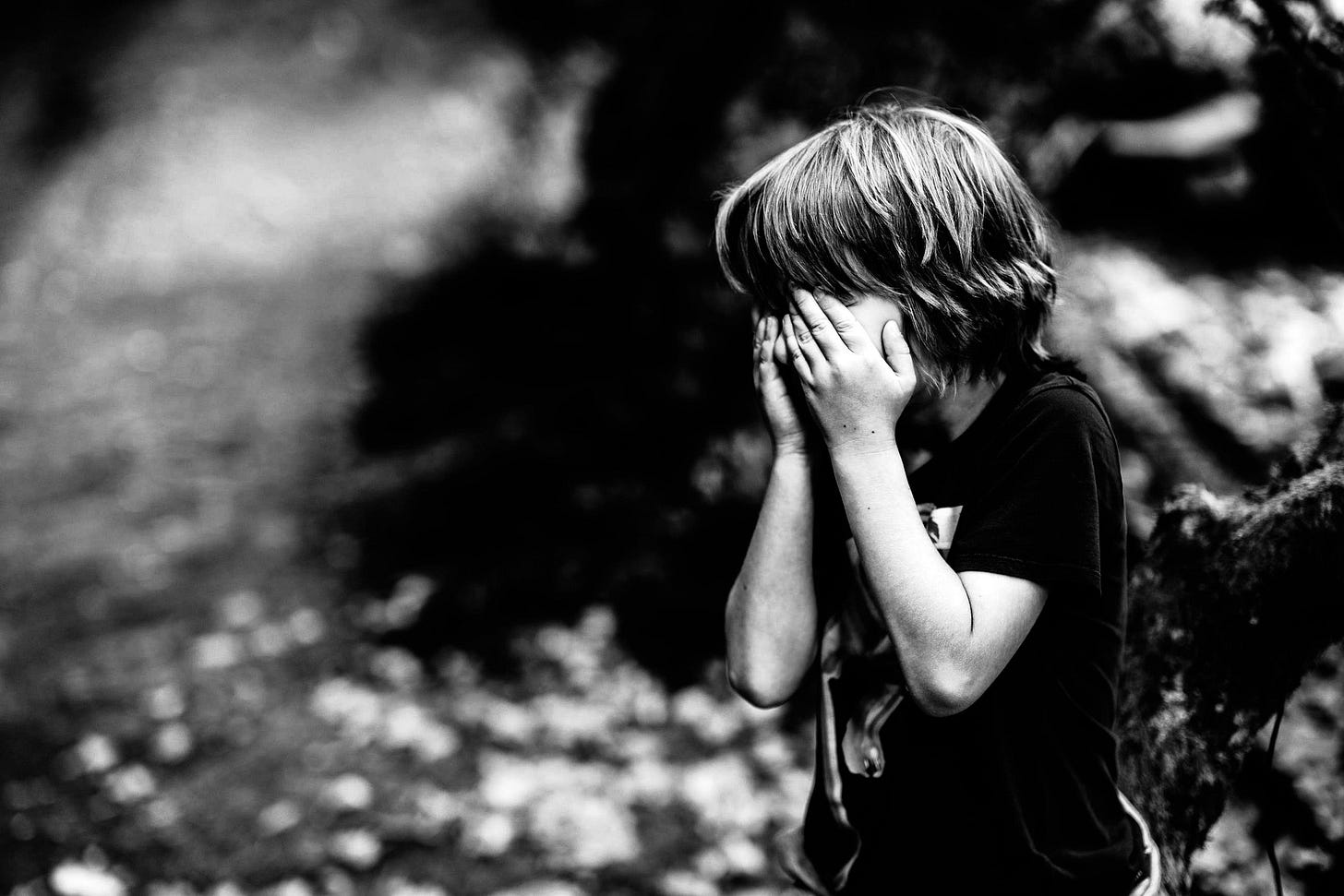 Photo of boy covering his eyes Photo of boy covering his eyes