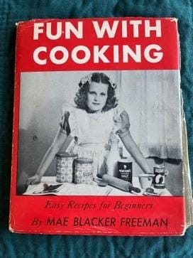 A red and white book with a child in a dress

Description automatically generated