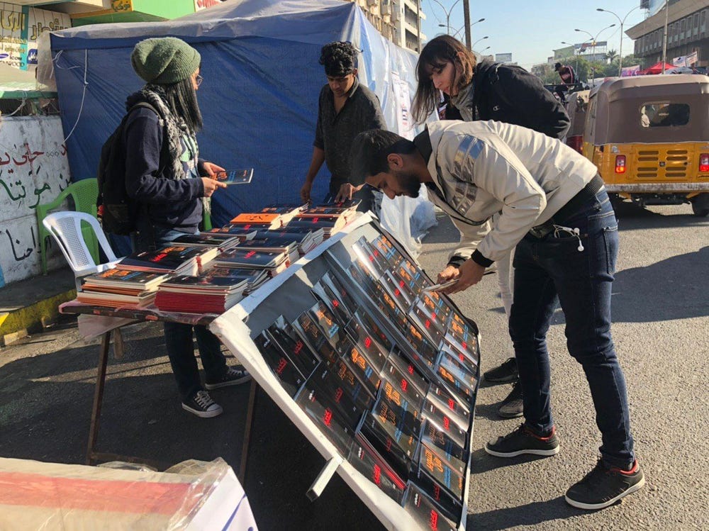 People around a stand selling books