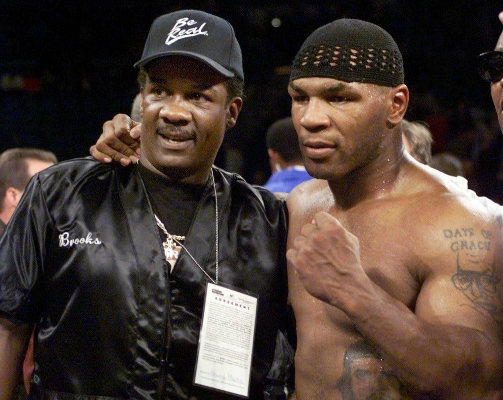 Mike Tyson and his trainer Tommy Brooks after a boxing match. Mike Tyson and his trainer Tommy Brooks after a boxing match.