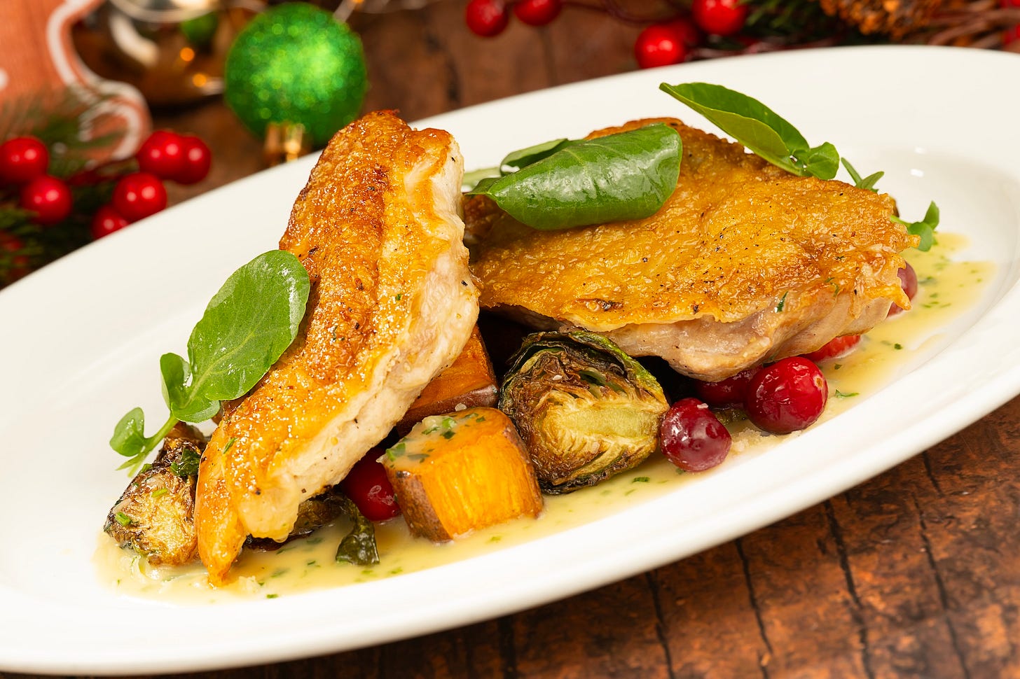 Poulet Rouge Chicken: Roasted sweet potatoes and brussels sprouts with a cranberry pan sauce