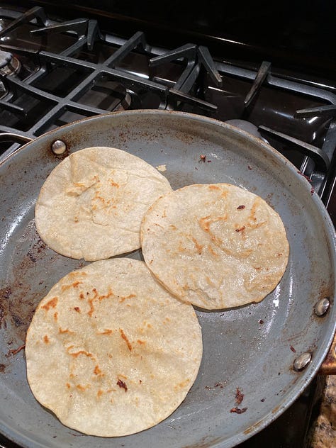 Warm your soft tacos, cook your beef and hard tacos then put it all together.