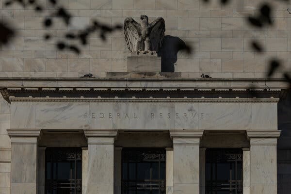 The outside of the Federal Reserve building, which has a large eagle statue on top. The outside of the Federal Reserve building, which has a large eagle statue on top.