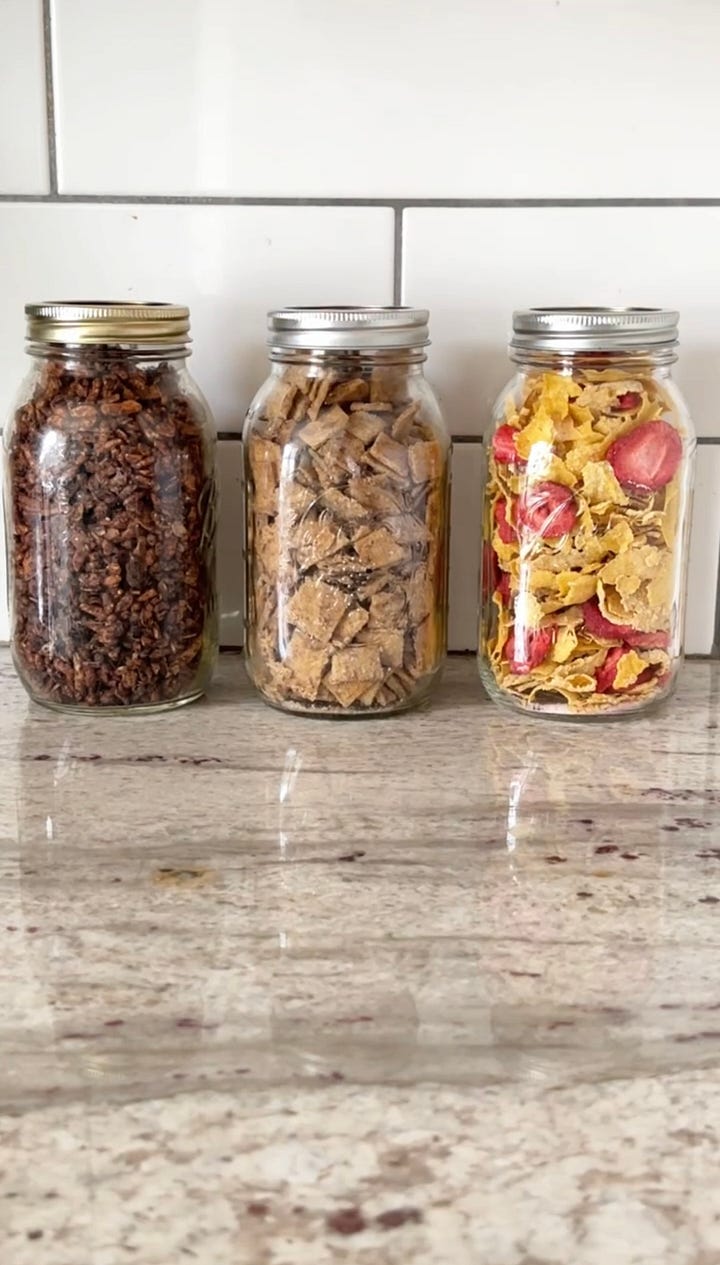 Jars of cereal and a bowl of cinnamon toast crunch with milk.