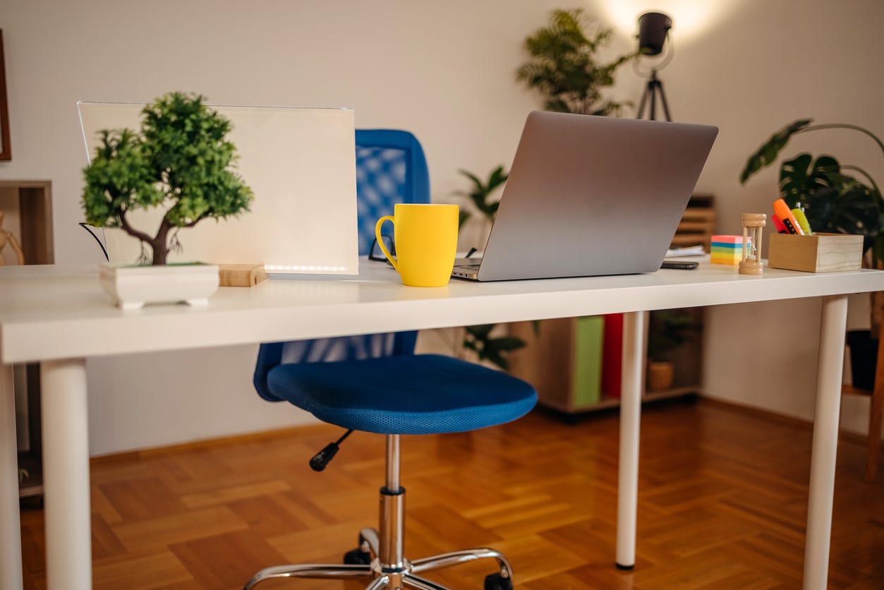 home office set-up: table, chair, laptop, stationery supplies