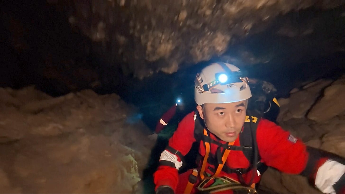 Tang Shengjie navigates through a narrowpoint in the cave during the training exercise in December 2025.