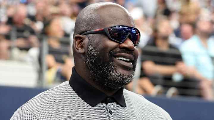 Sep 15, 2024; Arlington, Texas, USA; Former NBA player Shaquille O'Neal stands on the sidelines before a game between the New Orleans Saints and Dallas Cowboys at AT&T Stadium
