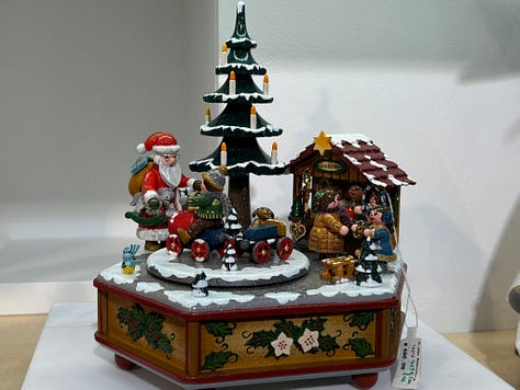 a gothic cathedral, man holding a mug of beer, a plate of sausages and bread, building by a river, a wall of cuckoo clocks, closeup of a christmas musical piece in the cuckoo shop