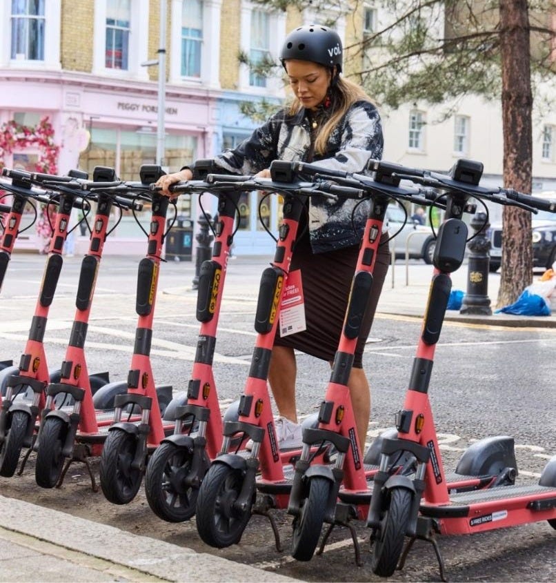 May be an image of 1 person, scooter, segway and text