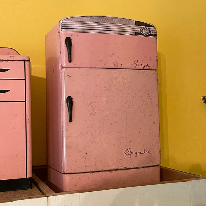 pink tin sink, sideboard, washing machine, and refrigerator in child sizes