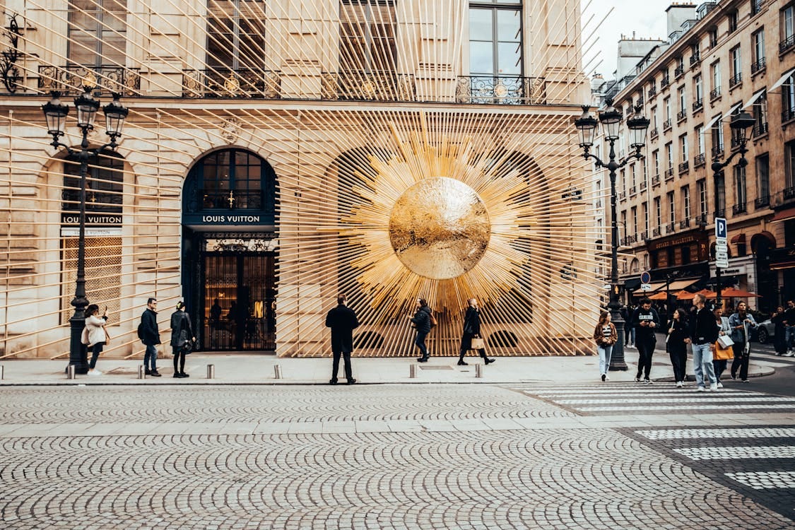 Free Elegant Louis Vuitton facade in bustling Paris street, showcasing modern artistic design. Stock Photo
