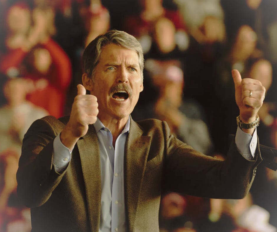 Eric Hovde stands with his fists raised and mouth open, mid-sentence. He is a late middle-aged white man with short hray hair and a small mustache.