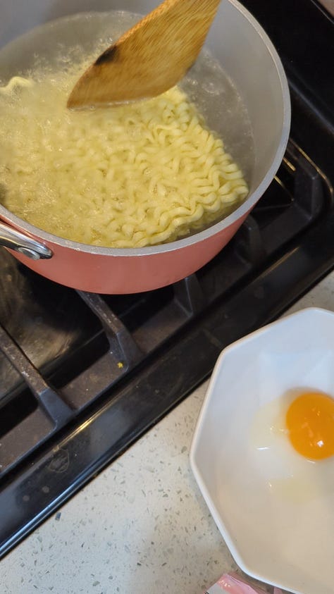 Buldak carbonara packet being opened, cooked, sauce packets mixed and finished noodles raised with chopsticks from the bowl.