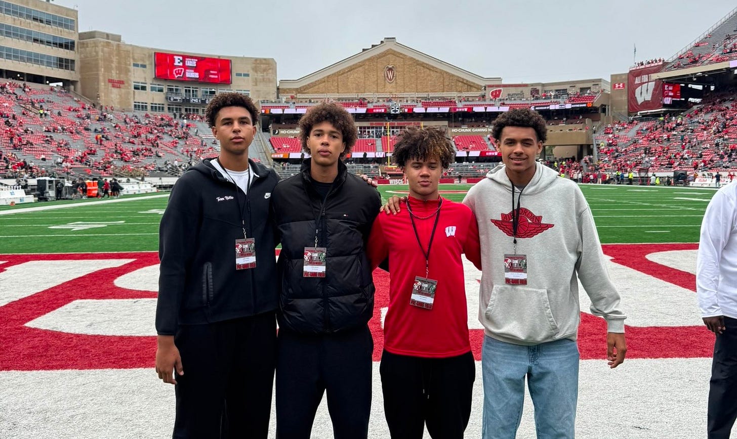 Wisconsin basketball targets Max McMullen, Jayden Jackson, Gibran Spector and Braylin Calhoun stand together on the field at Camp Randall Stadium during unofficial visits.