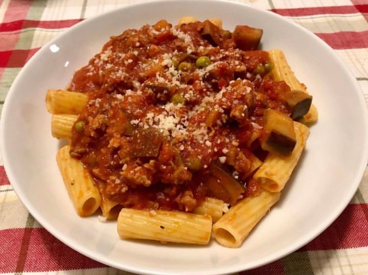 Rigatoni with ragu made with Italian sausage, zucchini, and peas