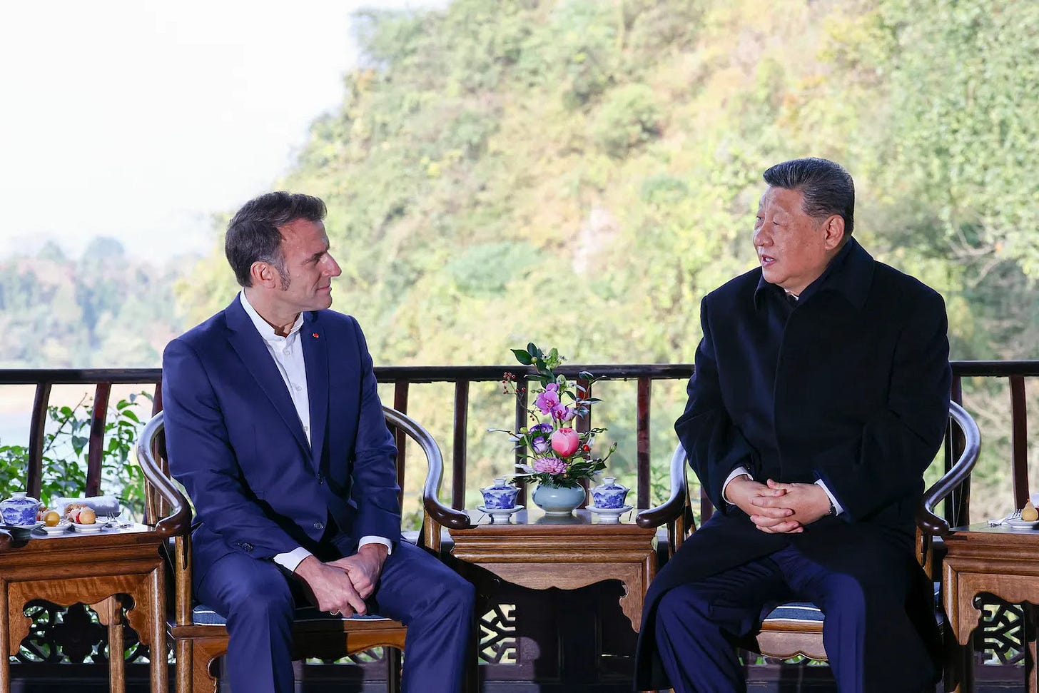 Chinese President Xi Jinping speaks with French President Emmanuel Macron during a visit at the Dujiangyan site in southwestern China.