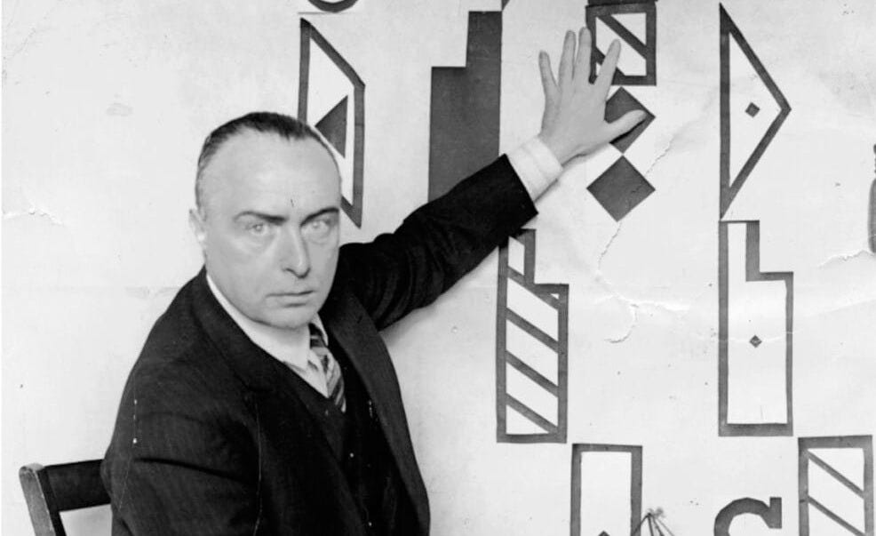 Rudolf von Laban sits next to his Labanotation signs.