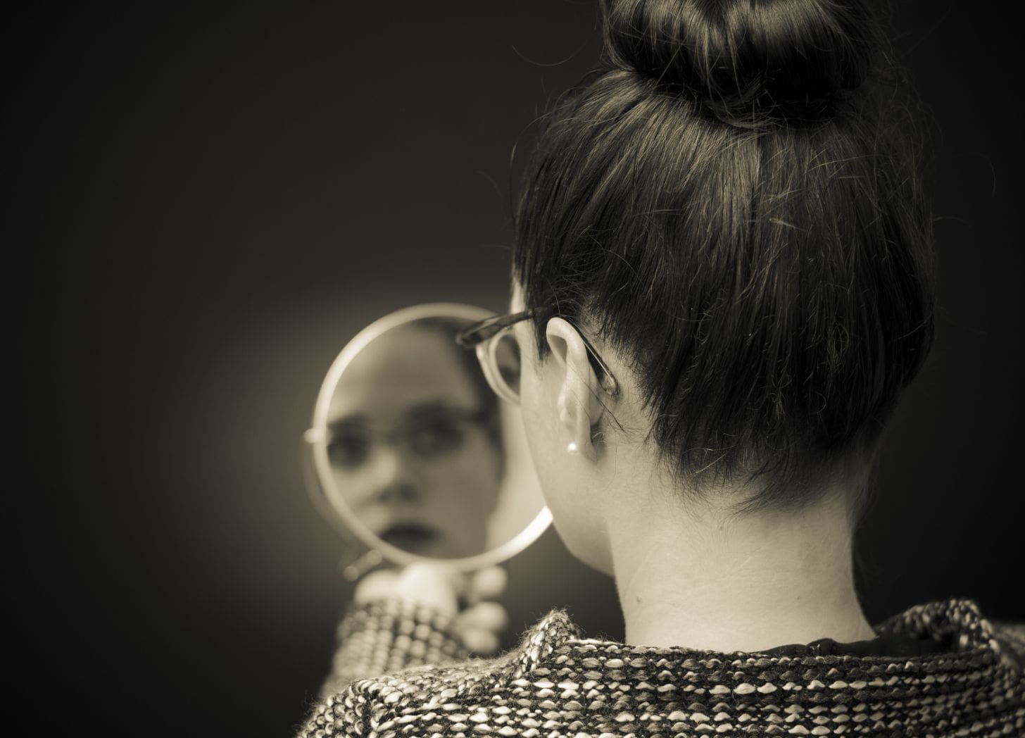 Hospitality operator looking into a mirror to reflect on guest experience and booking journey