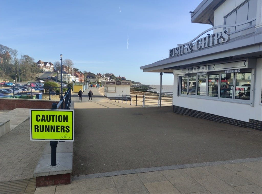 Caution runners sign on the prom, looking North.