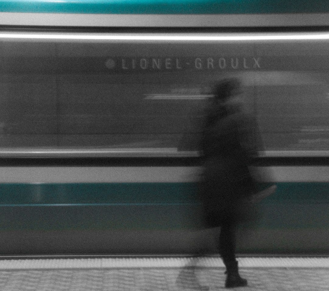 man in black jacket walking on sidewalk