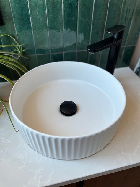 black tap, black shower, black door handle