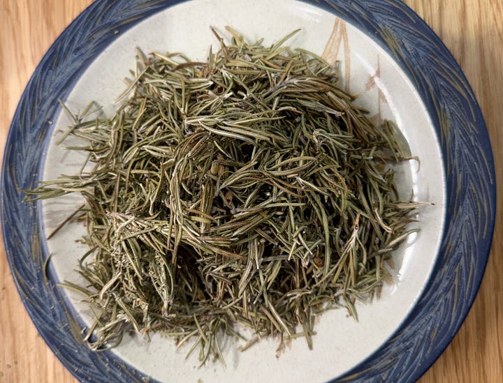 Narrow fresh green leaves and dried leaves of rosemary
