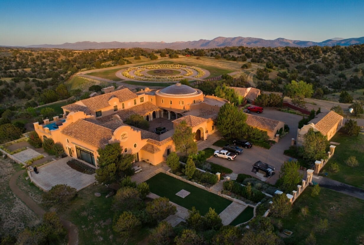 Aerial view of an isolated desert compound in New Mexico with a large mansion and private airstrip Aerial view of an isolated desert compound in New Mexico with a large mansion and private airstrip