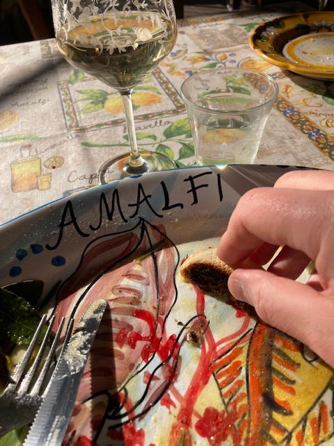 Empty plate of pasta with a hand holding a piece of bread mopping up sauce, with the second photo showing glasses of wine and sparkling water.