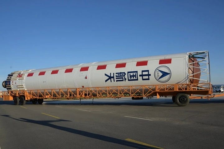 The Long March 4B first-stage heading to the launch pad and its fairing being placed atop of the launch vehicle on the launch pad.