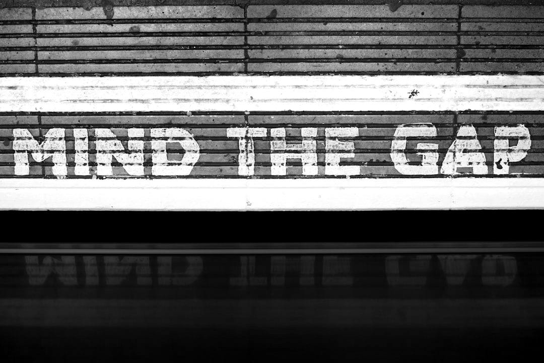 A sign that says mind the gap on the side of a train A sign that says mind the gap on the side of a train