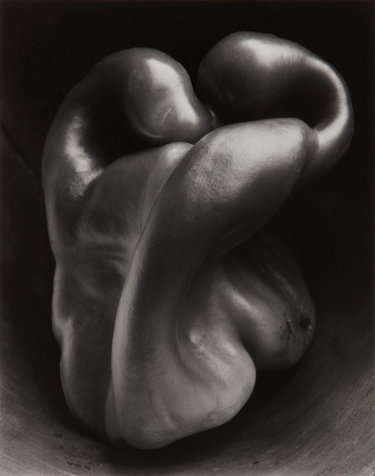A black and white close-up photo of an intricately curved bell pepper with smooth, glossy surfaces and dramatic lighting emphasizing its organic form. *Pepper No. 30* (1930) by Edward Weston; posthumous print by his son Cole Weston via [Wikimedia](https://commons.wikimedia.org/w/index.php?curid=123637244)