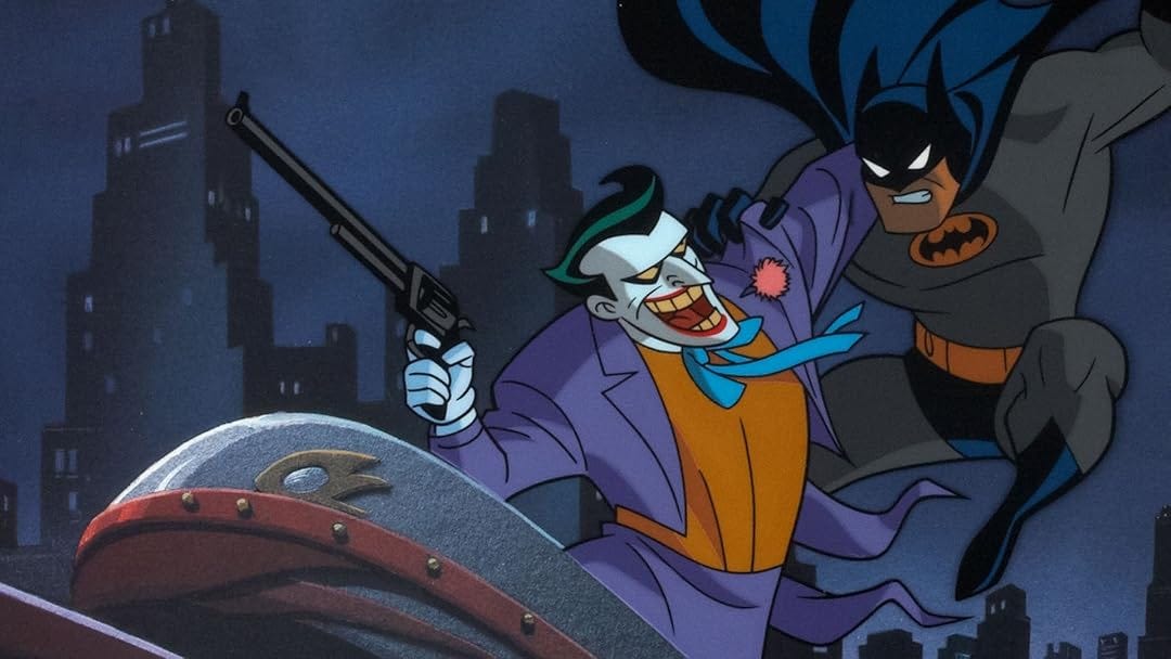 Batman leaping on The Joker, who holds a gun and laughs