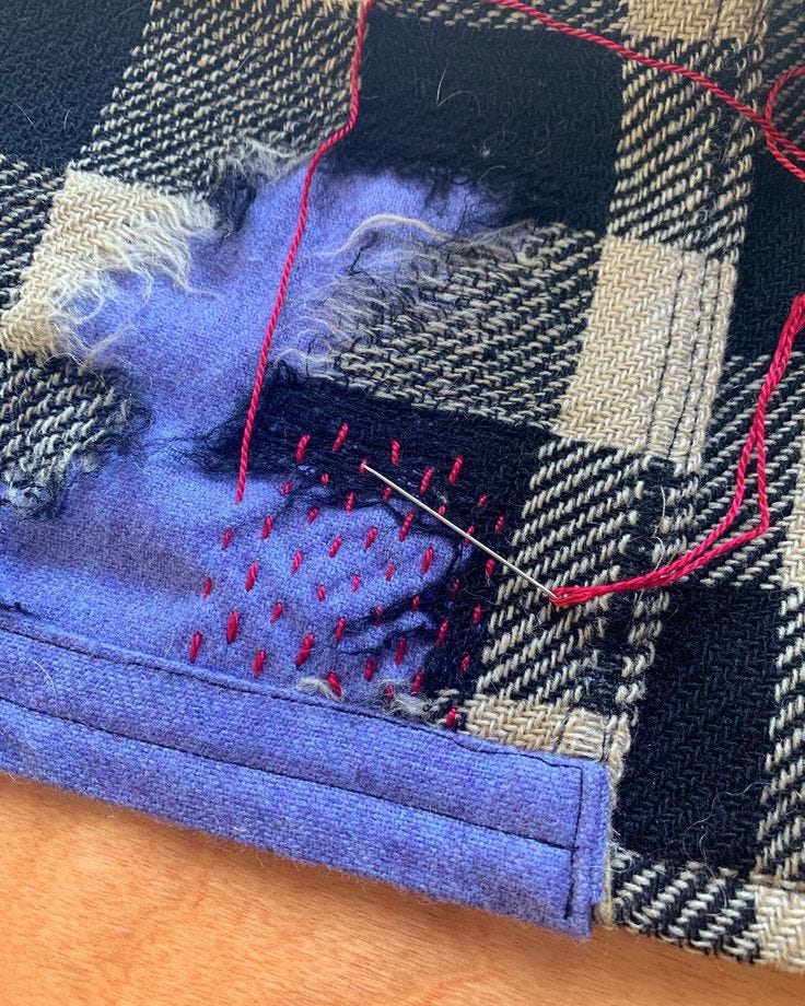 a worn out shirt with an in progress patch underneath