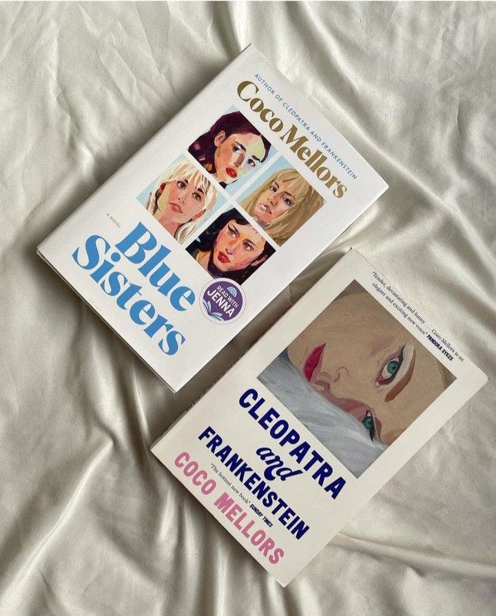 This may contain: two books sitting on top of a bed next to each other in front of a white sheet