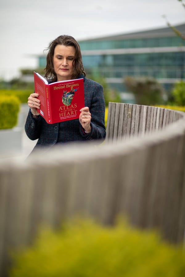 Photo of Lucinda reading Atlas of the Heart by Brené Brown