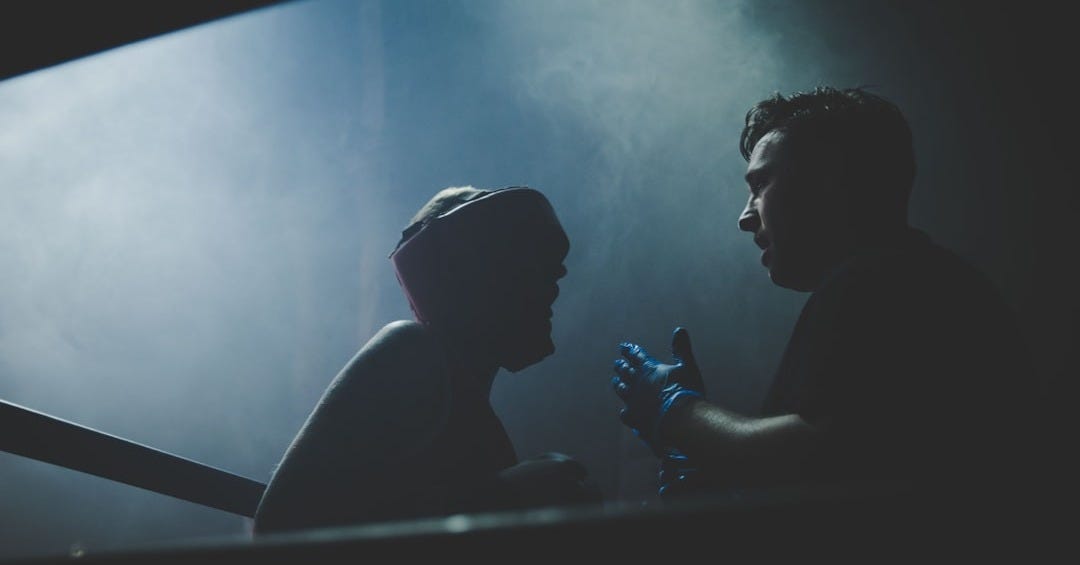 two men about to fight inside boxing ring