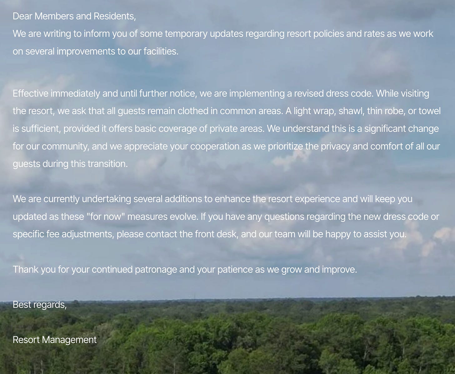 A screenshot of the notice posted on Emerald Lake Resort's website, with white text over a faded photo of clouds and a green treeline. Addressed to "Members and Residents" and signed "Resort Management," it informs guests of temporary policy and rate updates during facility improvements, asks that all guests remain clothed in common areas with a light wrap, shawl, thin robe, or towel for basic coverage, calls the change significant, describes the steps as "for now" measures that will evolve, and directs questions about the dress code or fee adjustments to the front desk.