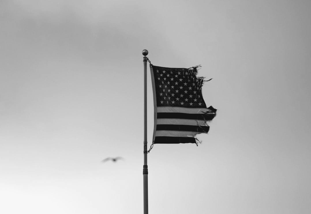 an american flag is flying in the wind an american flag is flying in the wind