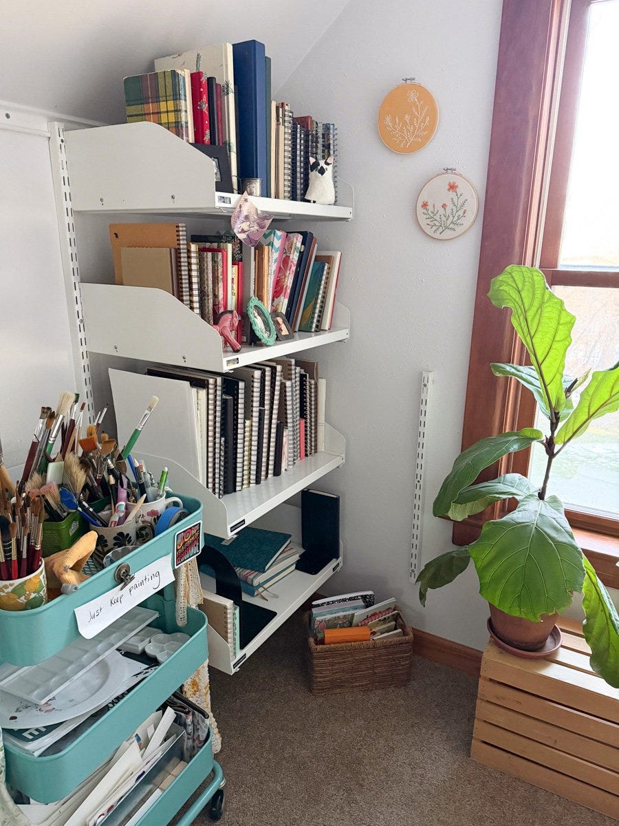 shelves in the corner of my studio are filled with sketchbooks and journals