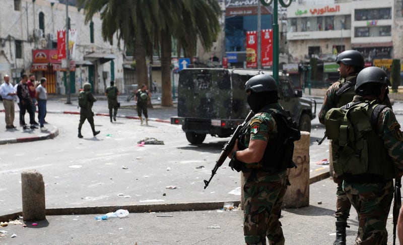 Palestinian Authority forces standing guard with a jeep Palestinian Authority forces standing guard with a jeep