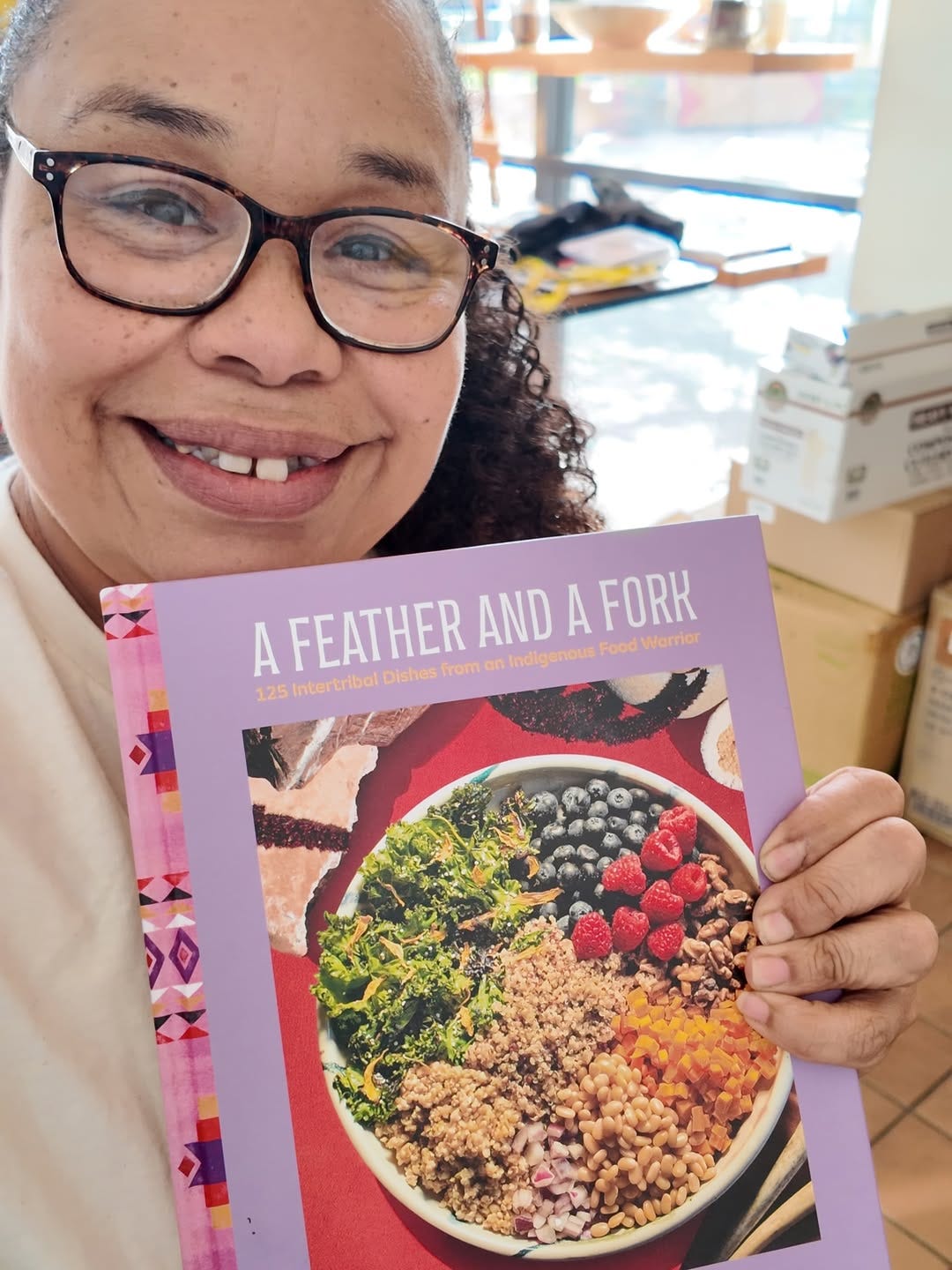 Chef Crystal holding her new cookbook, A Feather and a Fork