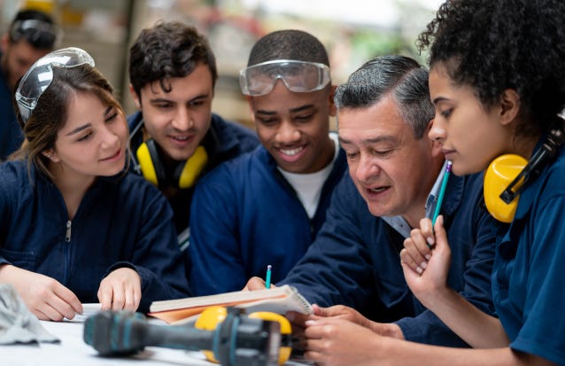 image representing high quality instruction with a teacher and students working together on a project