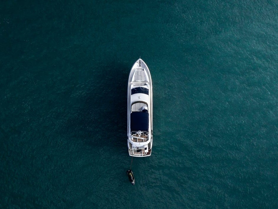 aerial photography of white yacht on calm waters