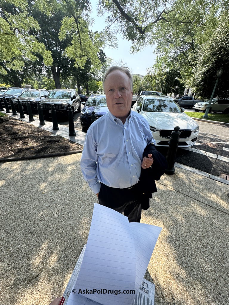 Man speaks with reporter holding notebook in parking lot on Capitol grounds © AskaPoldrugs.com Man speaks with reporter holding notebook in parking lot on Capitol grounds © AskaPoldrugs.com