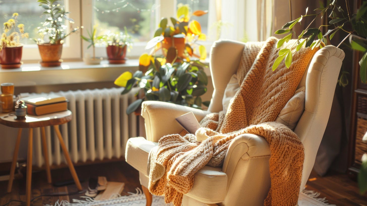 A cozy armchair with a knitted blanket in a sunlit room, surrounded by potted plants and books on a side table.